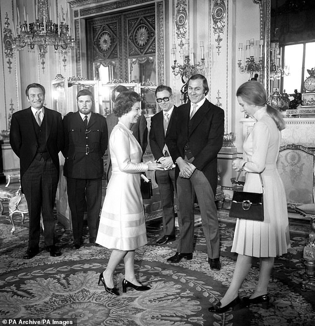 The Queen, watched by Princess Anne (right), thanked the seven heroes who went to the assistance of Princess Anne during the Ian Ball's attempt to kidnap her in Pall Mall