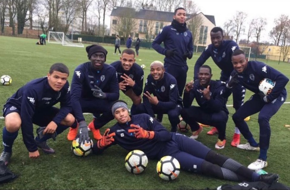 Soccer team posing on a field.