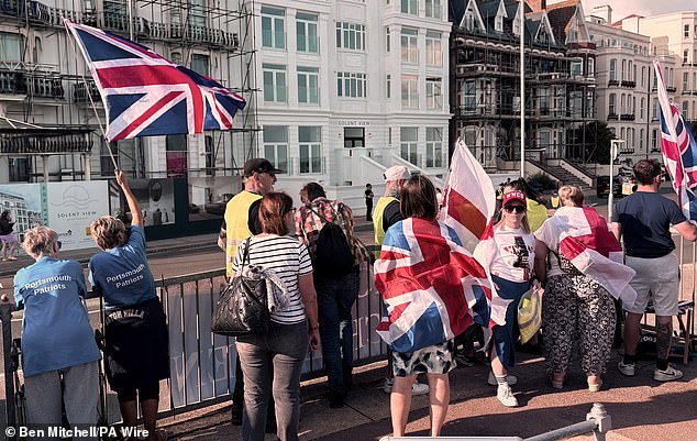 Protesters line up across the street from the Royal Beach Hotel