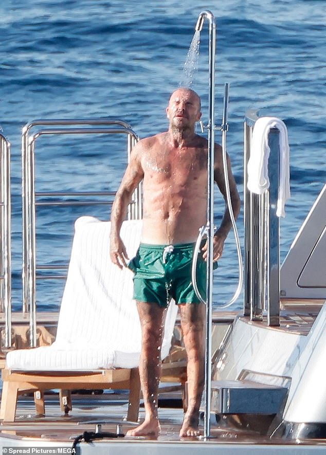 David flexed his abs as he cooled off in the shower after cuddling up to his fashion designer wife