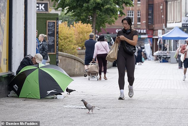 Pictured: a woman walks through the centre of the community town of Bedford which McCormack says many locals now deem 'unsafe'