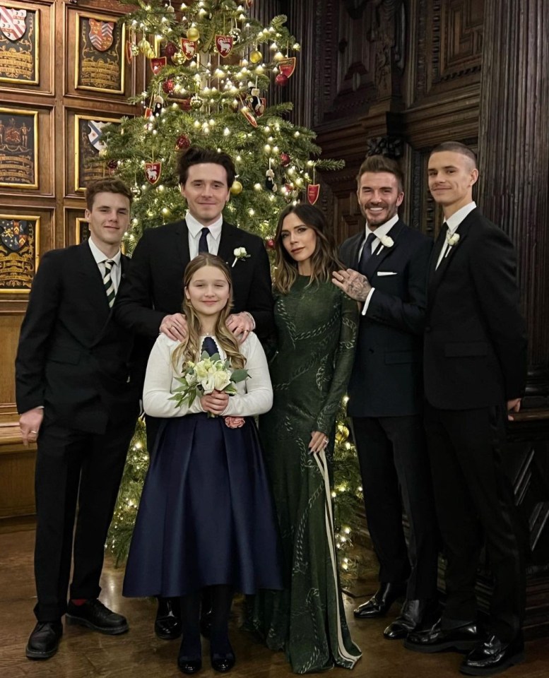 The Beckham family posing for a photo in front of a Christmas tree.