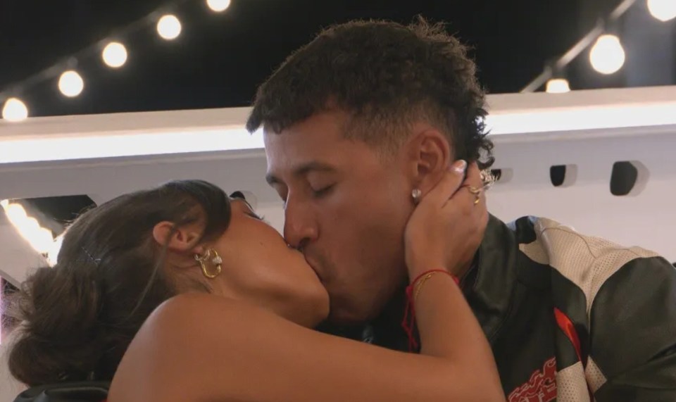 Screenshot of a couple kissing.