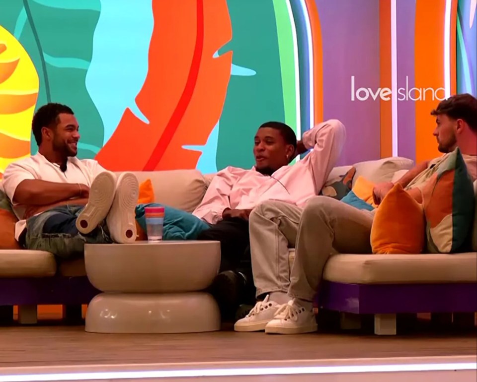 Three men from Love Island sitting on a couch and talking.