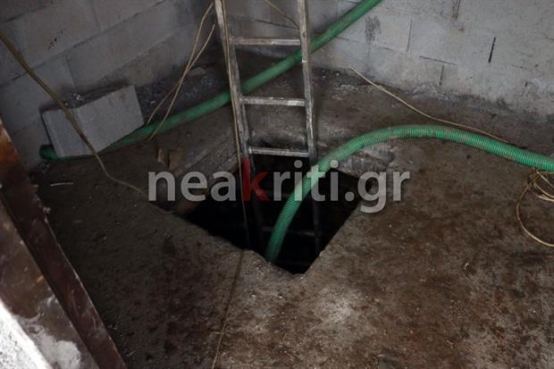 Ladder over a dark hole in a basement floor.