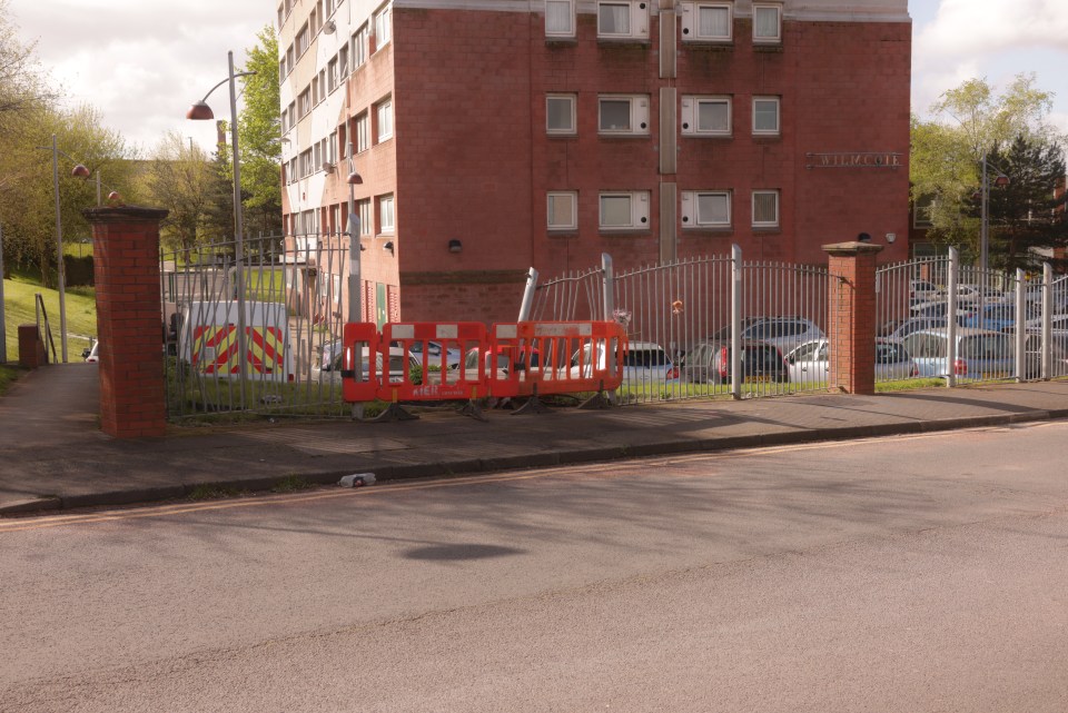 Tributes outside a Birmingham apartment building following a fatal car accident.