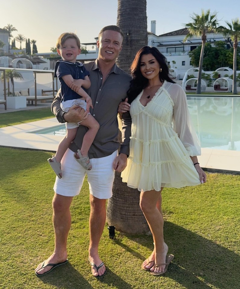Family portrait by a pool.