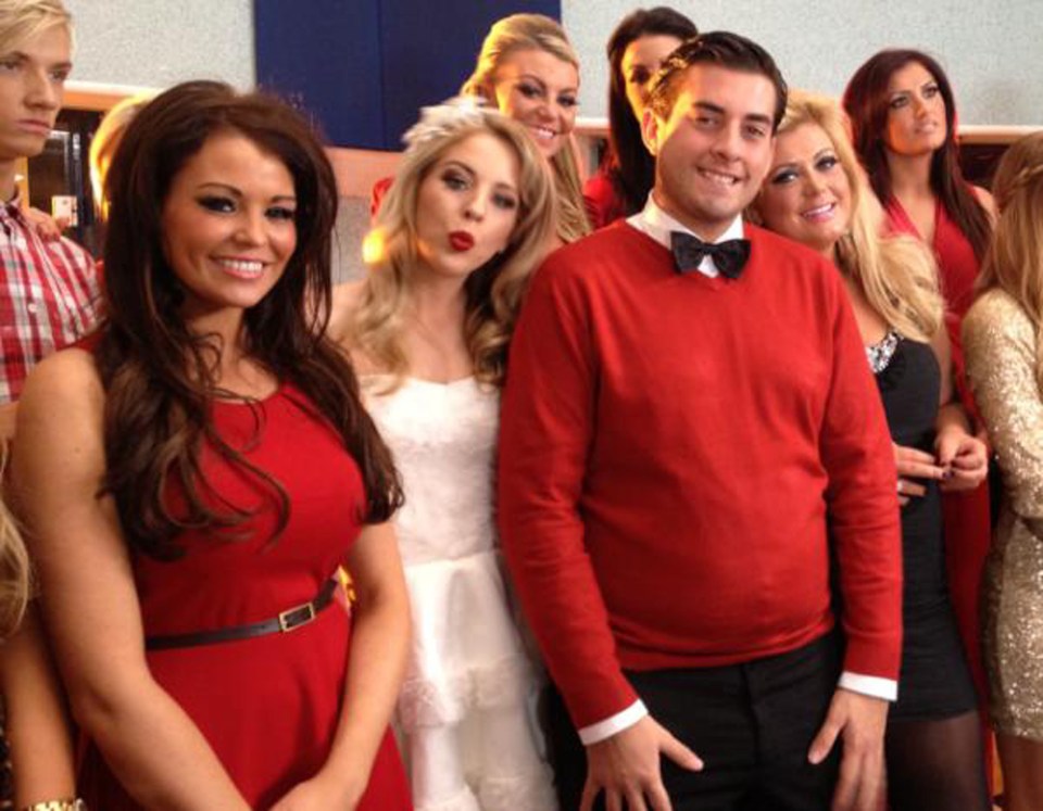 Group photo of several young adults, mostly women, in red and white dresses.