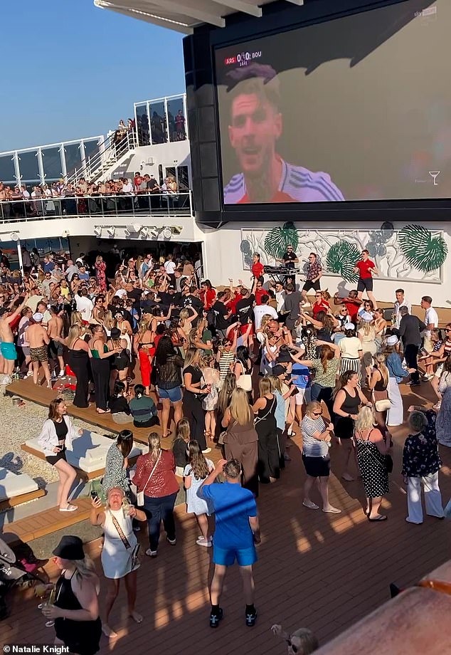 In the hours before, high-spirited crowds filled the mega ship - with music blaring from the speakers and football playing from a large poolside screen