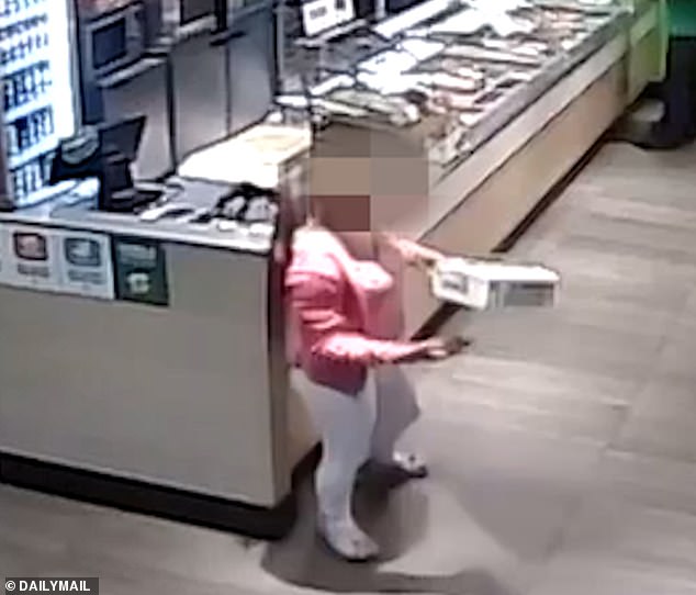 Pictured: One of the thieving teenagers taking an item from Subway. The pack of girls spend every afternoon drunk attempting to steal the cookie cabinet from Subway