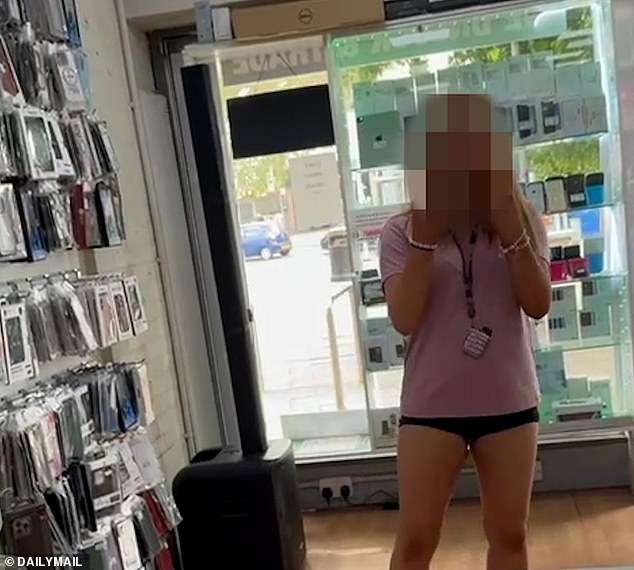 Pictured: A feral teen flipping off the manager of Phone Hub. The pack of girls only target stores run by ethnic minoritie