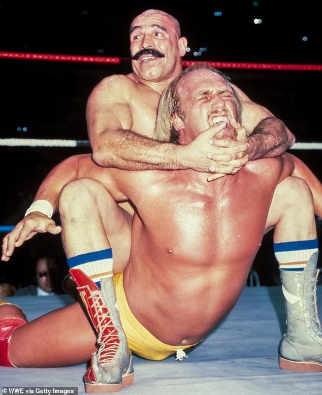 Hogan rose to fame after earning himself a full-time spot in the WWF in 1983 (pictured a year later in action with Iron Sheik)