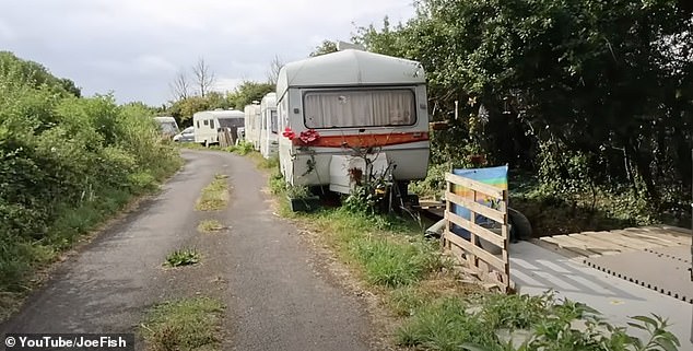 Nearby, more than 40 caravans and motorhomes have similar set ups with garden furniture and even makehsift decking - illegally