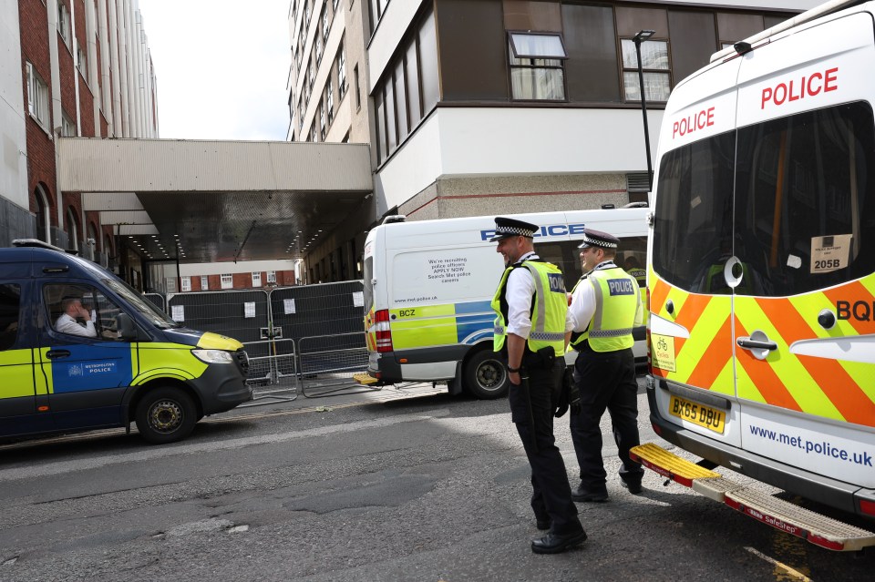 London police officers outside a hotel during a protest against asylum seekers being housed there.