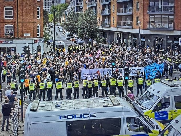 MANCHESTER: Police line the streets to separate the two groups of protesters