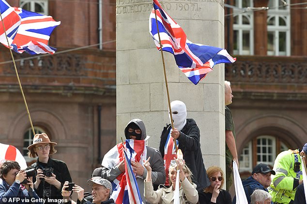 MANCHESTER: Masked supporters join the far-right Britain First party 'March for Remigration' rally
