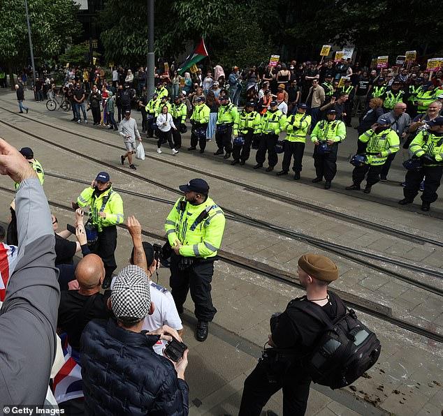 MANCHESTER: Police line up the streets to separate the two protesting groups