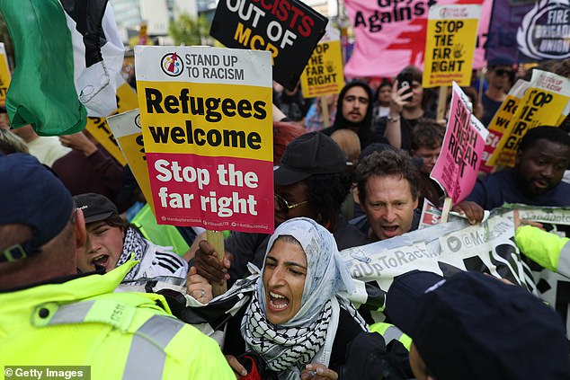 MANCHESTER: Woman at counter protesting holding up sign saying 'Refugees Welcome'