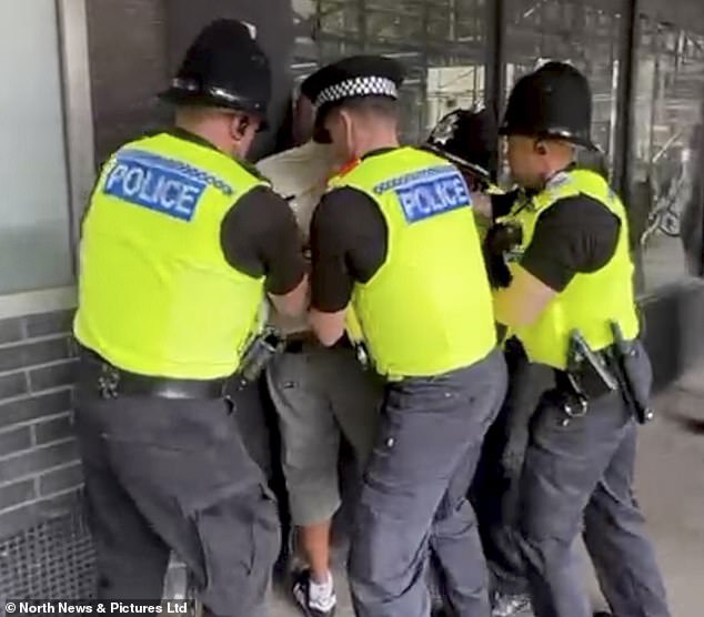An arrest is made during the anti-immigrant protest, dubbed the Great British National Protest