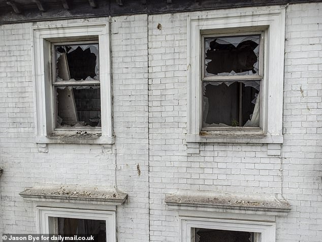 While parts of the hotel have been boarded up, the upper windows remain smashed in, with shards of broken glass around the edges