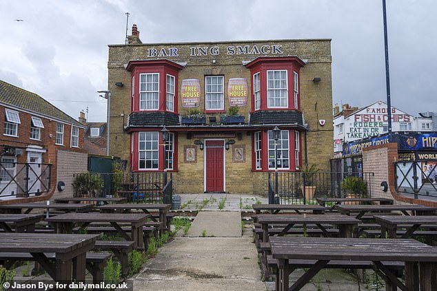 The Barking Smack pub, off which parts of the sign has fallen off, lays derelict on the seafront