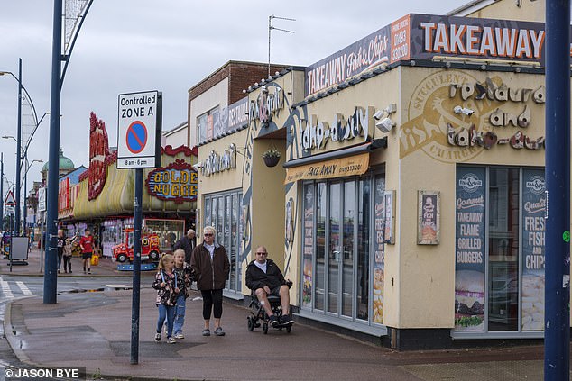 Despite the rainy weather when the Daily Mail visited on Thursday, visitors were still strolling down the pier