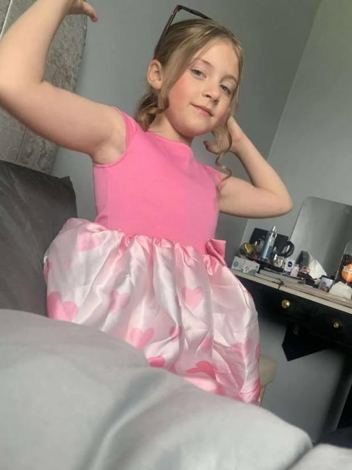 Girl in pink heart dress.