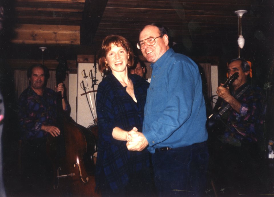 The Duchess of York dancing with a photographer in a restaurant.