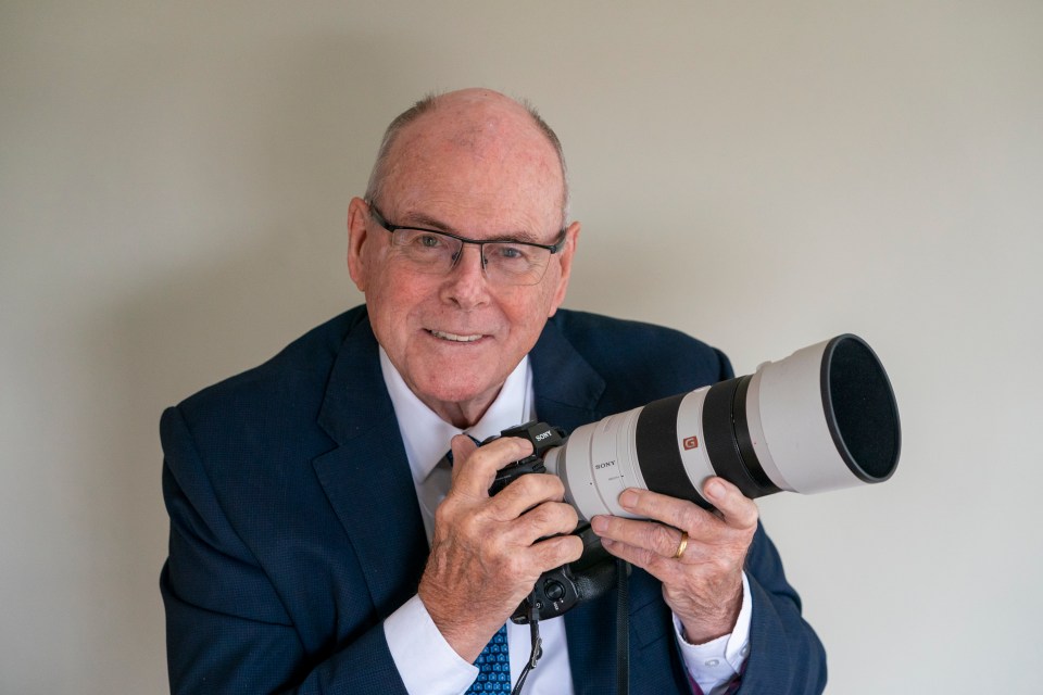 Portrait of Arthur Edwards holding a Sony camera.