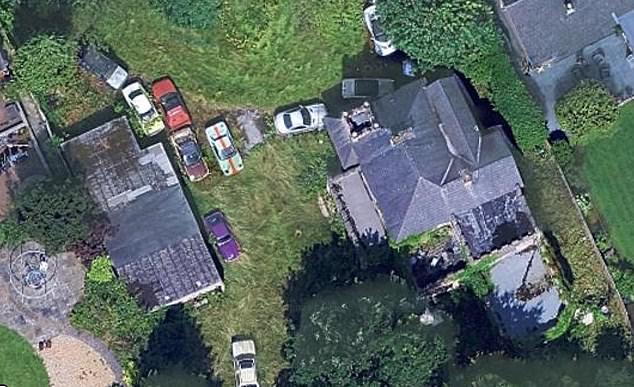 BEFORE: Satellite images show a bunch of classic cars rusting in the garden of the mansion