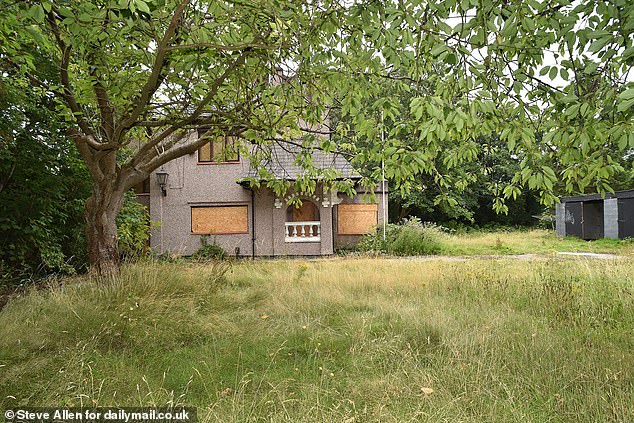 AFTER: The grass around the charming property has now grown long and ragged