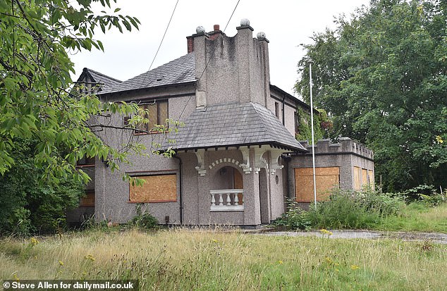 AFTER: The house, which has now been emptied and boarded up along with the cars removed, has recently been sold for a guide price of £325,000