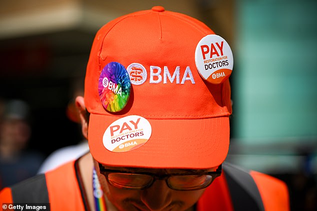 A BMA spokesperson said that the NHS England claims that the majority of resident doctors chose not to strike 'requires a huge stretch of the imagination'. Pictured: A striking doctor protests outside Bristol Royal Infirmary hospital