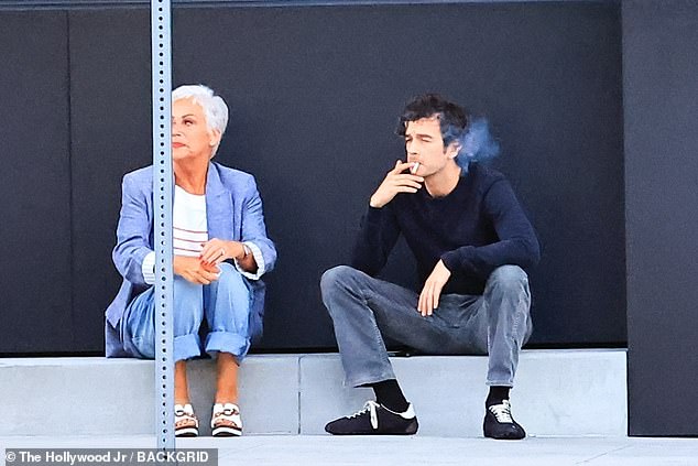 The former Coronation Street star looked glum as she stared into the distance, while Matty took the opportunity to puff on a cigarette while supporting is mother