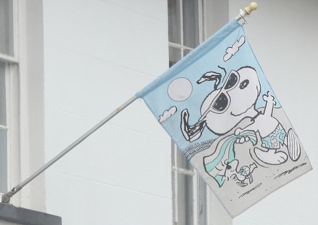 The Harry Potter star has hung a Snoopy flag (pictured) outside the nine-bedroomed mansion.