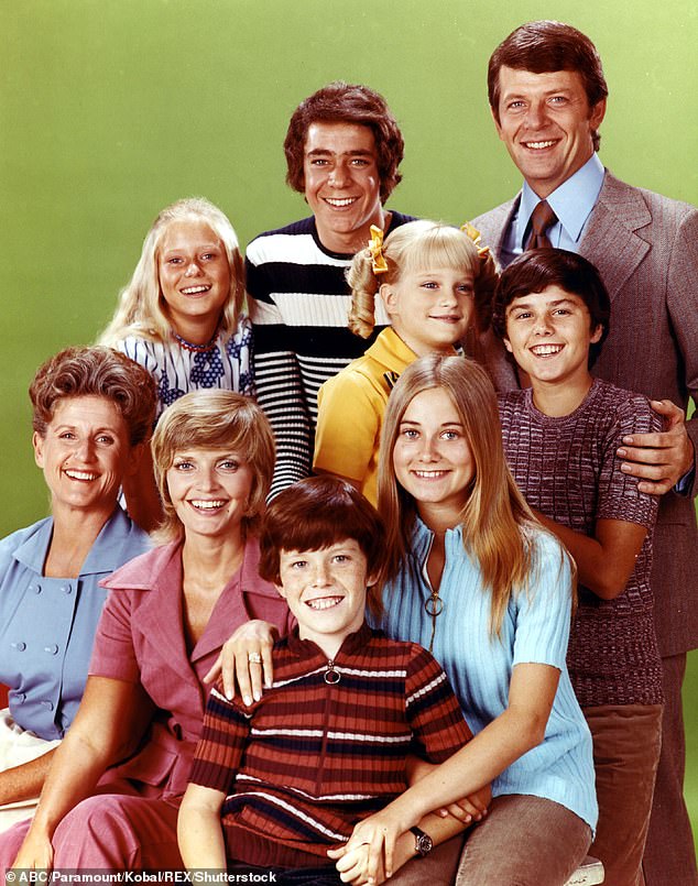 The Brady Bunch cast is pictured from left to right: Robert Reed, Barry Williams, Eve Plumb, Olsen, Christopher Knight, Ann B. Davis, Florence Henderson, Mike Lookinland, Maureen McCormick