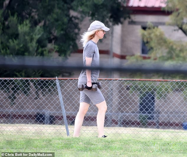 Holmes hair blew in the breeze as she completed her workout in the prison grounds