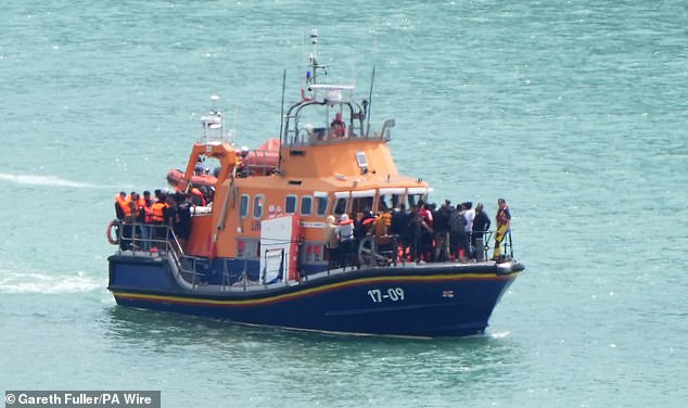 Under the proposed law, offenders could receive a prison sentence of up to five years and a hefty fine. Pictured: A group of people thought to be migrants are brought in to the Border Force compound in Dover, Kent, from an RNLI Lifeboat following a small boat incident in the Channel. Picture date: Wednesday July 30, 2025