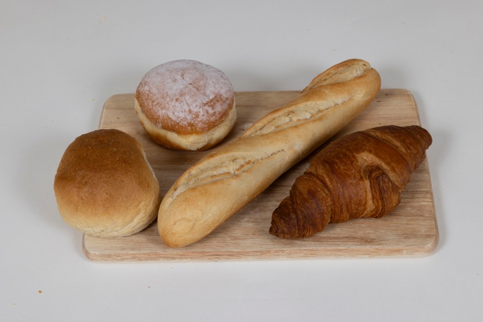 Assortment of bakery items on a wooden board.