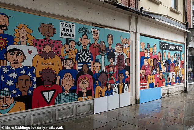 A boarded up storefront with a mural reading 'Port and Proud'. Around 19 per cent of stores on the high street are said to be lying empty