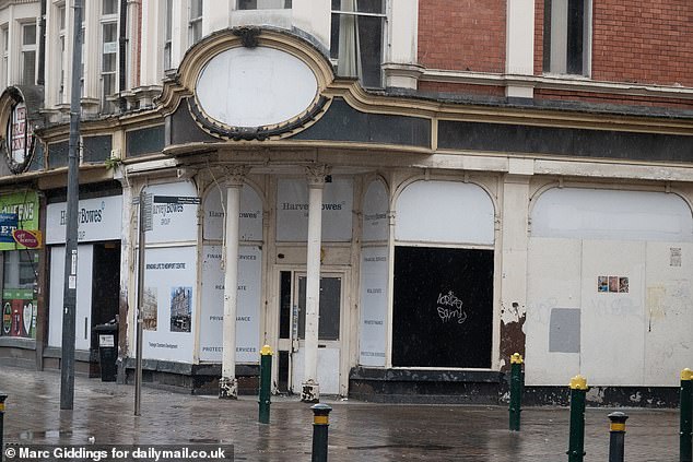 Another boarded up storefront. When the Daily Mail visited on a Thursday afternoon, the street was near empty