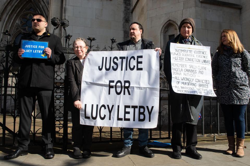 Protestors outside the High Court holding signs that say "Justice for Lucy Letby."