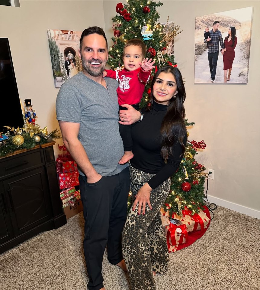 Family portrait in front of a Christmas tree.