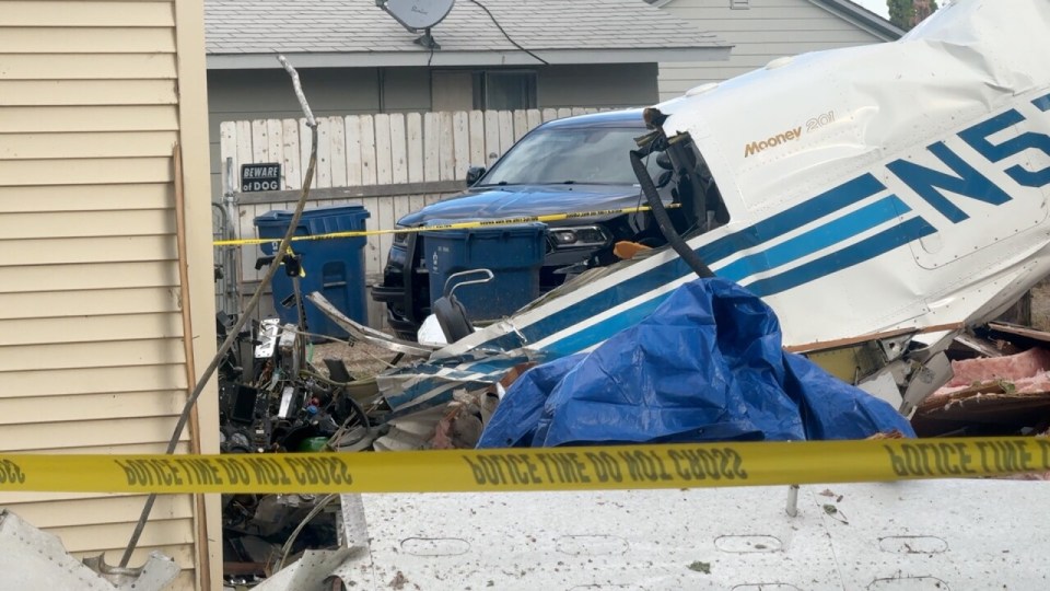 Debris from a small plane crash near a house.