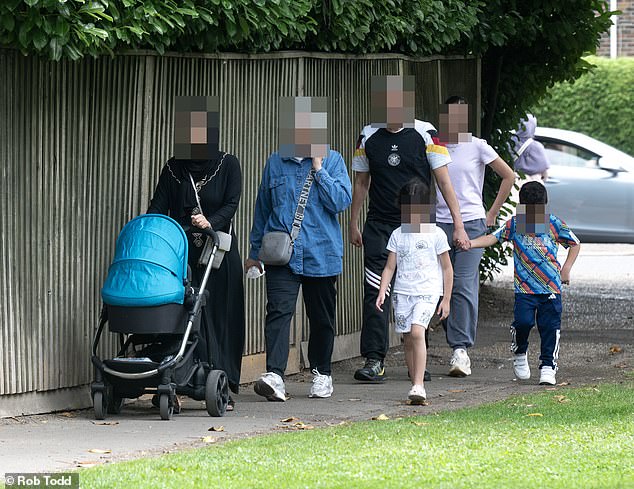 The four-star Copthorne hotel ¿ which is a 16th century farmhouse - is part of the Millenium hotel and has been housing asylum seekers for more than four years and a message on its website says it is ¿not accepting reservation requests¿. Above, migrants leaving the hotel