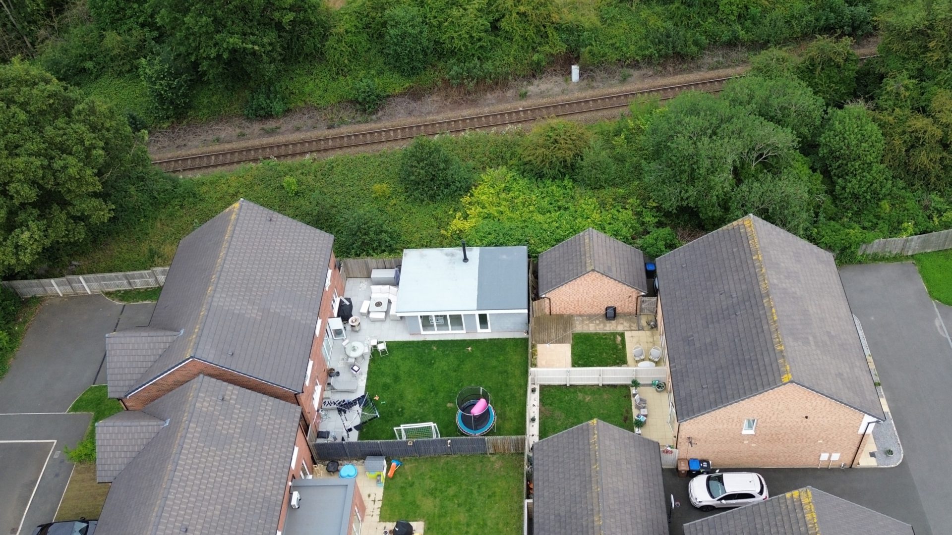 Aerial view of a summer house extension and surrounding houses.
