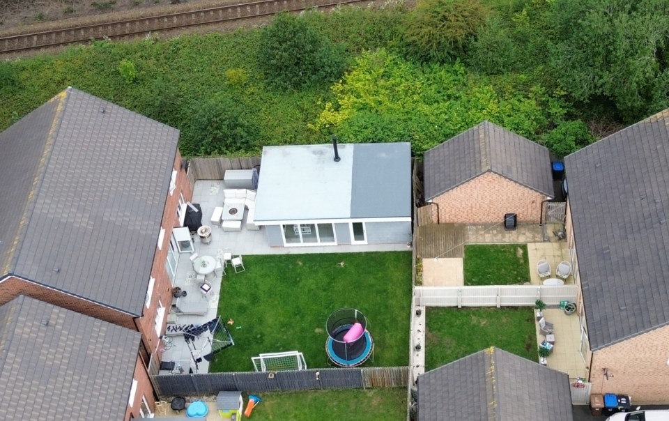 Aerial view of a summer house extension and surrounding garden.