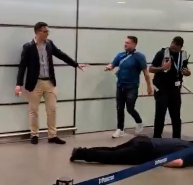 Footage shows the former EDL leader - whose real name is Stephen Yaxley-Lennon - pacing back and forth beside the unresponsive man