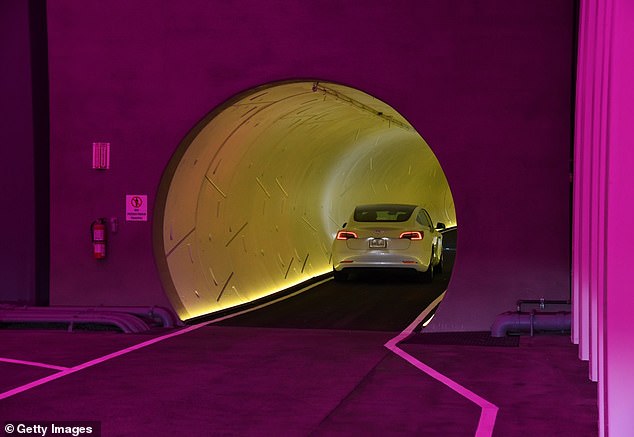 A Tesla car drives through a tunnel in the Central Station during a media preview of the Las Vegas Convention Center Loop on April 9, 2021