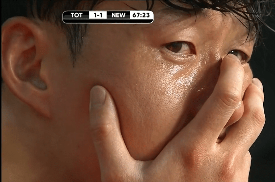 Upset man wiping tears from his face.